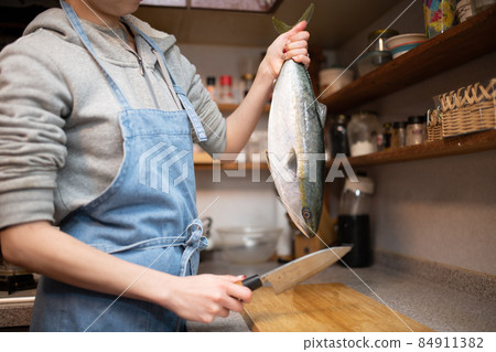 Female cooking fish Female cooking fish 84911382
