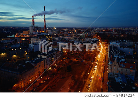 Steam from pipes over night city, aerial view 84914224