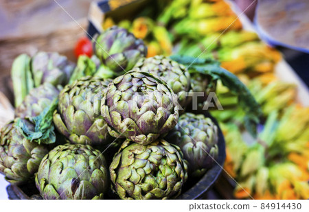 Street still life. Rome, outdoor restaurant decoration with fresh seasonal vegetables .Italian food and ingredients, artichokes and zucchini flowers 84914430