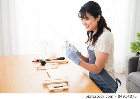 A woman doing DIY at home A woman doing DIY at home 84914876
