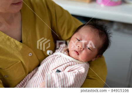Breastfeeding mom and 1 month old baby Breastfeeding mom and 1 month old baby 84915106