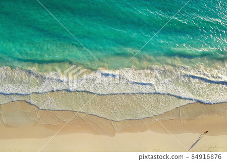 Man run along ocean surf by seascape, top view Man run along ocean surf by seascape, top view 84916876