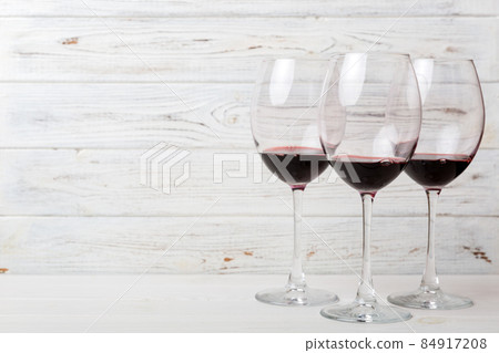 Many glasses of red wine at wine tasting. Concept of red wine on colored background. Top view, flat lay design Many glasses of red wine at wine tasting. Concept of red wine on colored background. Top view, flat lay design 84917208