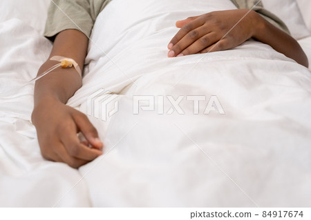 Little boy with dropper in his arm lying in bed Little boy with dropper in his arm lying in bed 84917674