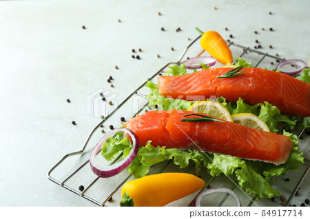 Concept of cooking salmon on white textured background 84917714