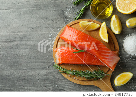 Concept of cooking salmon on gray textured table 84917753