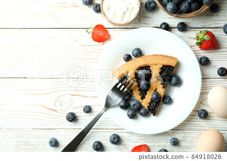 Concept of delicious dessert with blueberry pie on white wooden table 84918026