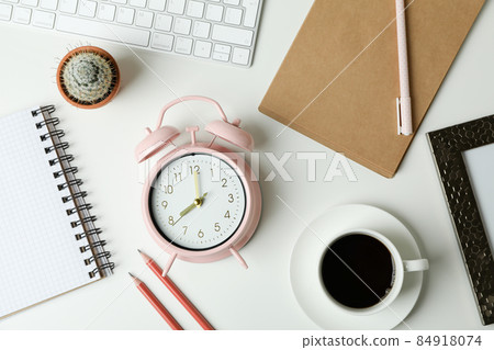 Workplace concept with alarm clock on white background 84918074