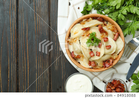 Concept of tasty food with vareniki or pierogi on wooden table 84918088