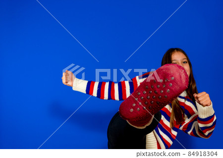 Pretty Spanish preteen girl throwing a self defense front kick. She prepares for adult life and to be able to defend herself Pretty Spanish preteen girl throwing a self defense front kick. She prepares for adult life and to be able to defend herself 84918304
