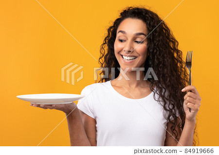 Portrait of Smiling Latin Lady Holding Fork And Plate Portrait of Smiling Latin Lady Holding Fork And Plate 84919666