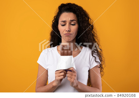 Sad Latin Lady Holding Chocolate At Studio Sad Latin Lady Holding Chocolate At Studio 84920108