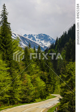 A beautiful scenic road high in the mountains in Romania. Nature background, selective focus. A beautiful scenic road high in the mountains in Romania. Nature background, selective focus. 84921384