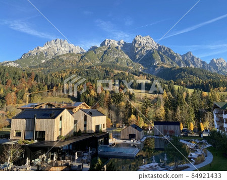 View from hotel window in Leogang village on the mountain range Leoganger Steinberge in the Alps mountains background Austria View from hotel window in Leogang village on the mountain range Leoganger Steinberge in the Alps mountains background Austria 84921433