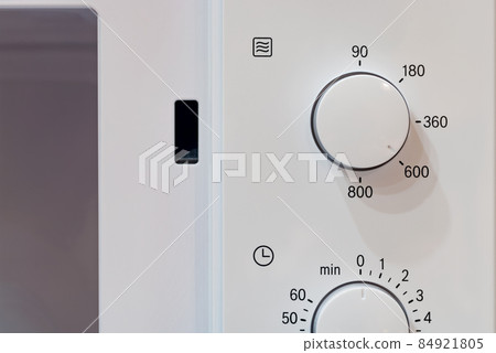 Opened classic microwave oven. Closeup. 84921805