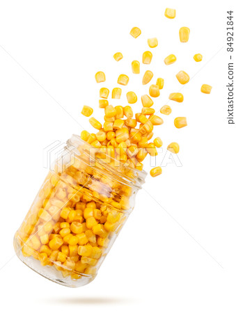 Corn flies out of a can on a white background. Isolated Corn flies out of a can on a white background. Isolated 84921844