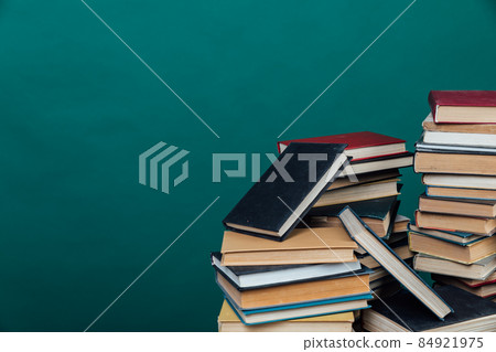 stacks of books for teaching knowledge of the university library green background 84921975