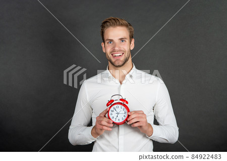 Happy manager hold alarm clock. Business punctuality 84922483