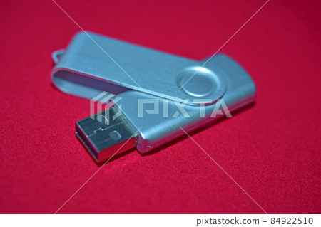 USB flash drive on a red velvet background 84922510