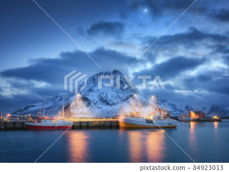 Fishing boats on the sea, snowy mountains, sky clouds and moon 84923013