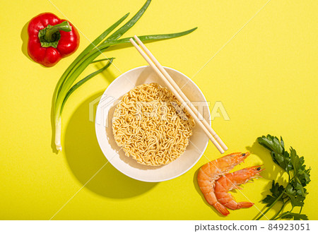Ingredients for cooking asian noodles on yellow background top view 84923051