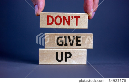 Do not give up symbol. Wooden blocks with words 'do not give up'. Beautiful grey background. Copy space. Business, motivational and do not give up concept. 84923576