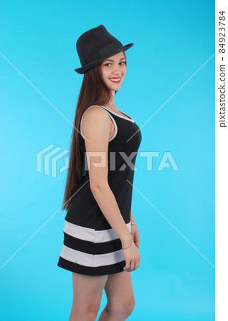 Beautiful young girl in black hat on his head Beautiful young girl in black hat on his head 84923784