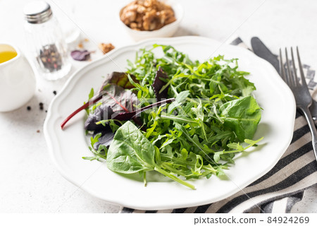Healthy vegan green salad mix on plate Healthy vegan green salad mix on plate 84924269