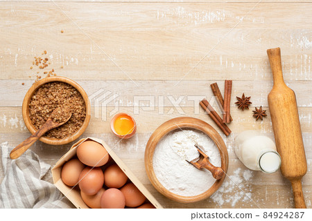 Ingredients for baking a cake on wooden table background 84924287