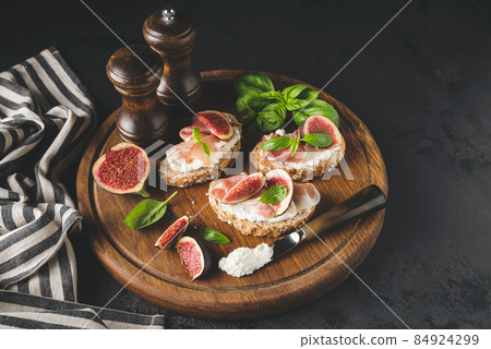 Italian bruschetta toast with ham, ricotta cheese and figs Italian bruschetta toast with ham, ricotta cheese and figs 84924299