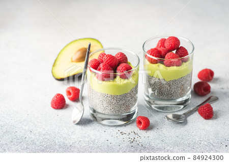 Vegan chia seed pudding with avocado mousse layer and raspberries Vegan chia seed pudding with avocado mousse layer and raspberries 84924300