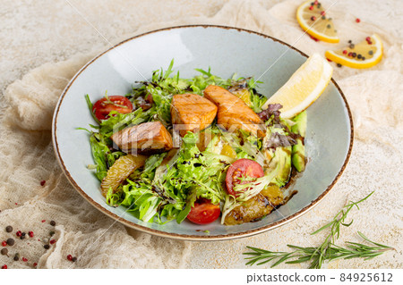 Salad with salmon, orange and avocado. Salad with salmon, orange and avocado. 84925612
