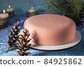 Beautiful delicious Christmas cake with romantic light and reflection of cones - romantic dessert by candlelight with pine needles 84925862