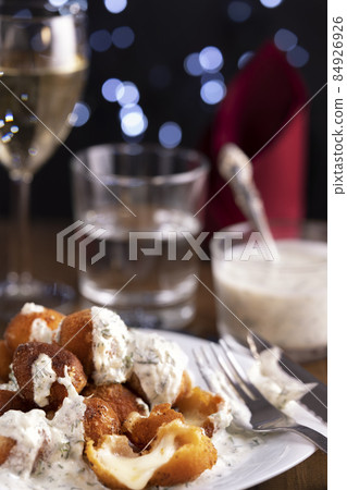 Fried mozzarella cheese balls under creamy sauce and wine. Christmas and New Year restaurant dinner 84926926
