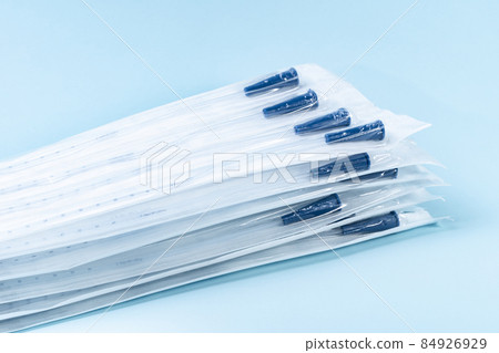 Rusch male and female all purpose catheter on blue background, straight tipped intermittent catheters designed for a single use, packaged individually and sterile 84926929