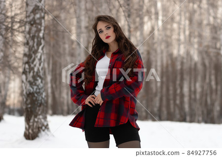 Woman with red lips in winter forest Woman with red lips in winter forest 84927756