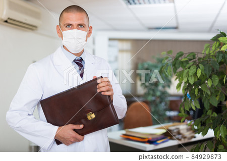 Man doctor standing at medical office 84929873