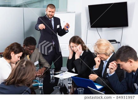 Businessman expressing dissatisfaction with teamwork of colleagues at meeting Businessman expressing dissatisfaction with teamwork of colleagues at meeting 84931997