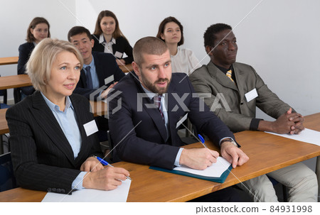 Group of employees listening to business training 84931998