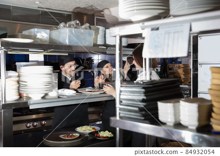 Adult kitcheners are taking order from waiter Adult kitcheners are taking order from waiter 84932054