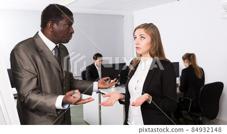 Outraged African businessman scolding frustrated girl 84932148