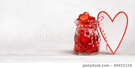 Heart shaped greeting card and a jar full of hearts. Valentines day Heart shaped greeting card and a jar full of hearts. Valentines day 84933159