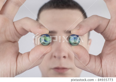 Conceptual shot of an eye crystalline lens replacement. Ophthalmic surgery. Return of sight. Removal of cataracts. Surgical intervention in the eyeball. Doctor holds the implant near the patient Conceptual shot of an eye crystalline lens replacement. Ophthalmic surgery. Return of sight. Removal of cataracts. Surgical intervention in the eyeball. Doctor holds the implant near the patient 84935773