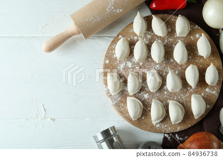 Concept of cooking vareniki or pierogi on white wooden table Concept of cooking vareniki or pierogi on white wooden table 84936738