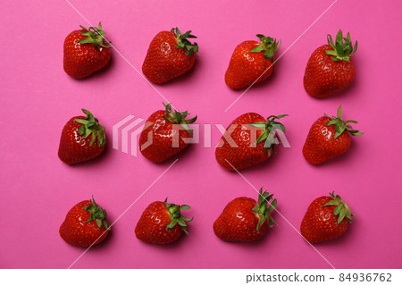 Fresh tasty strawberry with leaves on pink background Fresh tasty strawberry with leaves on pink background 84936762