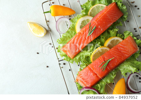 Concept of cooking salmon on white textured background Concept of cooking salmon on white textured background 84937052