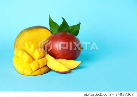 Tasty ripe mango fruit on blue background 84937367