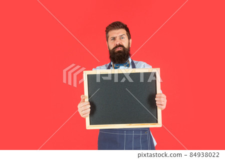 Anxious bearded man hold blackboard. Barbershop price board. Barbershop advertising, copy space 84938022