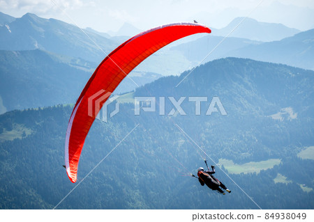 paragliding flight in the mountains. Le Grand-Bornand, France paragliding flight in the mountains. Le Grand-Bornand, France 84938049