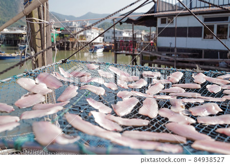 Traditional Hong Kong old wooden house, sun dried fish, boat and river in countryside 84938527